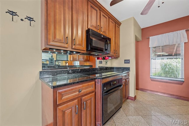 10122 Niblic Dr, Saint Louis, MO 63114 - kitchen with black appliances, a ceiling fan, brown cabinets, dark stone counters, and granite floors