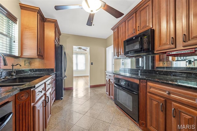 10122 Niblic Dr, Saint Louis, MO 63114 - kitchen featuring a ceiling fan, granite floors, black appliances, and brown cabinetry