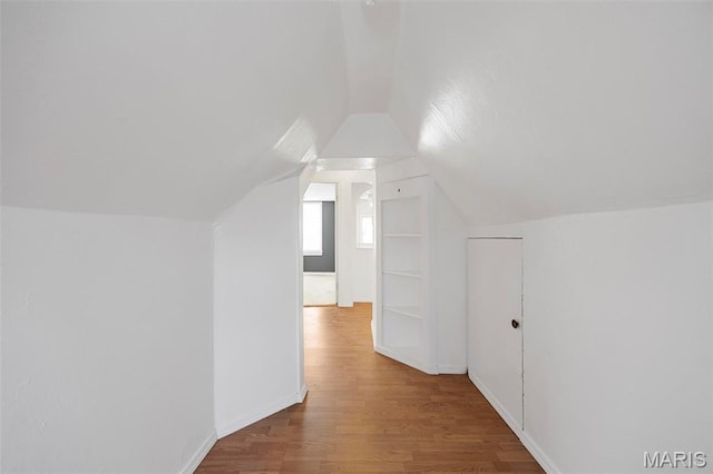 10122 Niblic Dr, Saint Louis, MO 63114 - additional living space featuring wood finished floors and vaulted ceiling