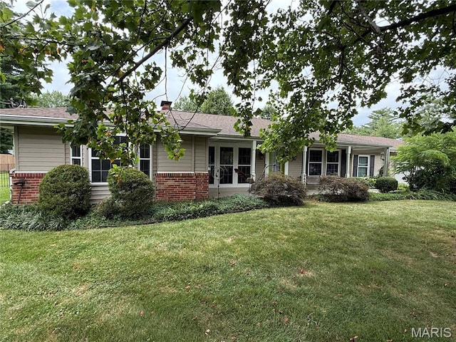 9457 Chavez Dr, Sunset Hills, MO 63127 - ranch-style house with brick siding, a front yard, and a chimney
