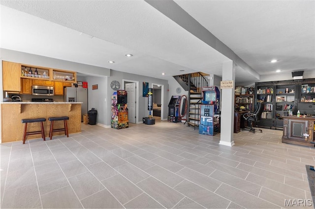 441 Rue Martel, Bonne Terre, MO 63628 - below grade area featuring stainless steel refrigerator with ice dispenser, recessed lighting, stairway, light tile patterned flooring, and a textured ceiling