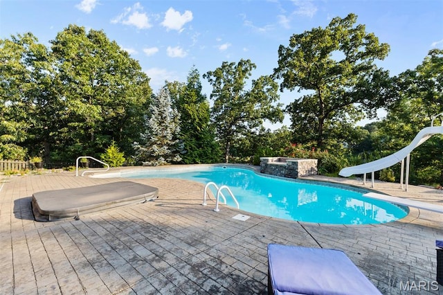 441 Rue Martel, Bonne Terre, MO 63628 - outdoor pool featuring a water slide and view of wooded area