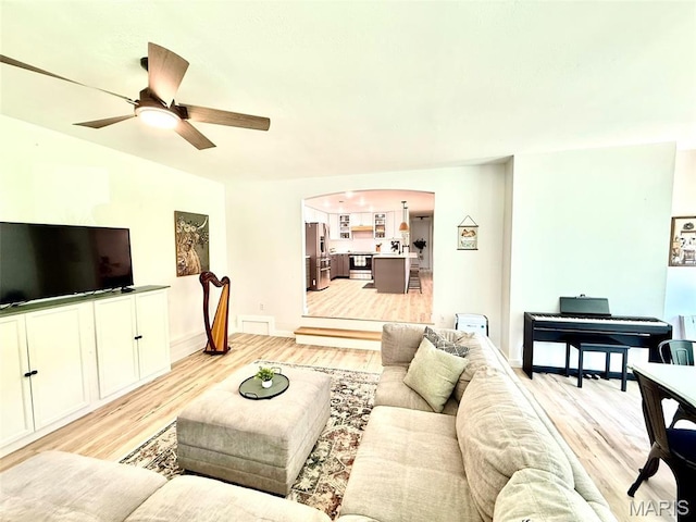 10107 Cannon Mines Rd, Cadet, MO 63630 - living area with light wood-style flooring, arched walkways, and ceiling fan