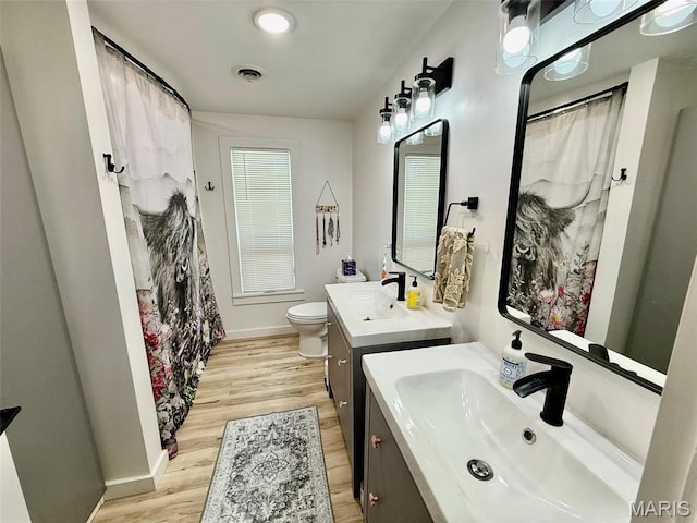10107 Cannon Mines Rd, Cadet, MO 63630 - full bathroom with wood finished floors, two vanities, and a shower with curtain