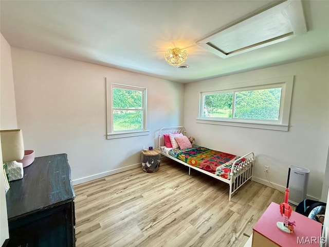 10107 Cannon Mines Rd, Cadet, MO 63630 - bedroom with attic access, multiple windows, and wood finished floors