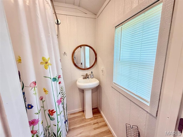 10107 Cannon Mines Rd, Cadet, MO 63630 - bathroom featuring wood finished floors, vaulted ceiling, and curtained shower