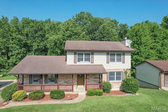 25 Whispering Oaks Dr, Washington, MO 63090 - view of front of house featuring covered porch, a front yard, a chimney, and brick siding