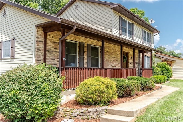 25 Whispering Oaks Dr, Washington, MO 63090 - view of front facade with covered porch and brick siding