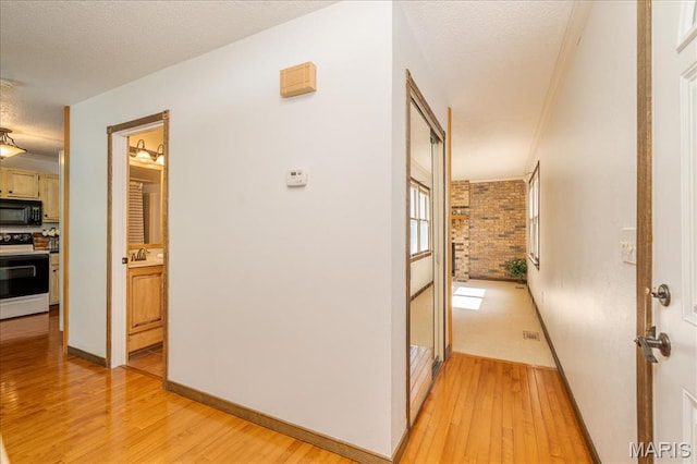 25 Whispering Oaks Dr, Washington, MO 63090 - hallway featuring light wood-type flooring and a textured ceiling
