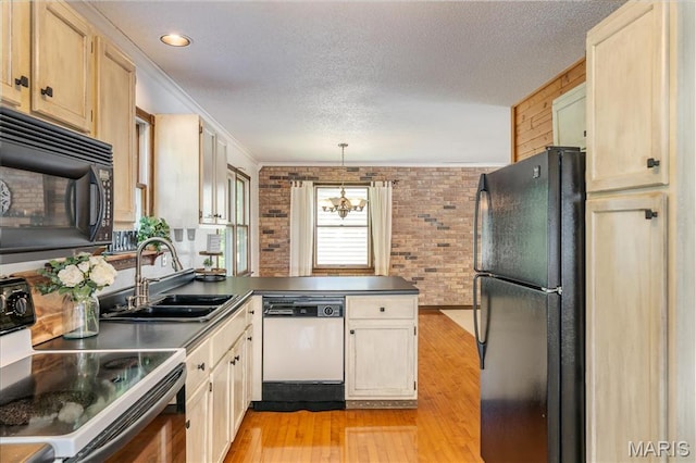 25 Whispering Oaks Dr, Washington, MO 63090 - kitchen featuring black appliances, a peninsula, light wood finished floors, brick wall, and a textured ceiling