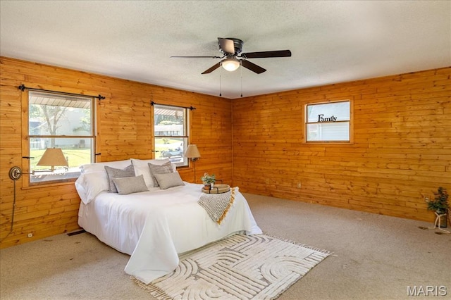 25 Whispering Oaks Dr, Washington, MO 63090 - bedroom featuring carpet, a textured ceiling, wood walls, and ceiling fan
