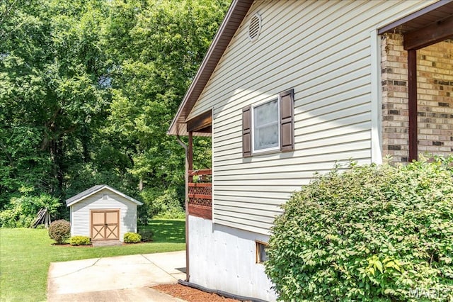 25 Whispering Oaks Dr, Washington, MO 63090 - view of side of property with a storage shed, a lawn, and a patio area