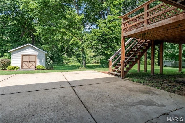 25 Whispering Oaks Dr, Washington, MO 63090 - view of patio with a storage unit, view of wooded area, and stairway