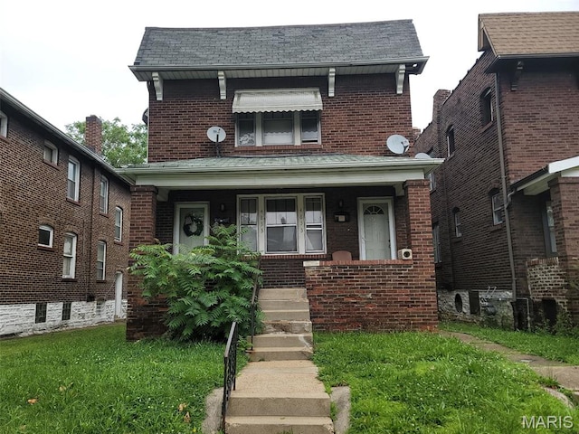 4833 Penrose St, Saint Louis, MO 63115 - traditional-style house featuring a porch, brick siding, a front lawn, and roof with shingles