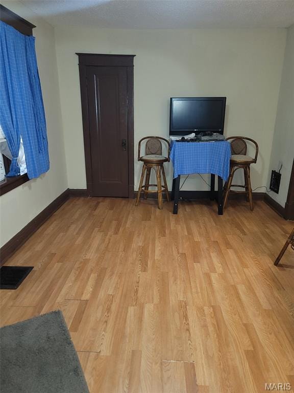 4833 Penrose St, Saint Louis, MO 63115 - living room featuring light wood-style flooring and baseboards
