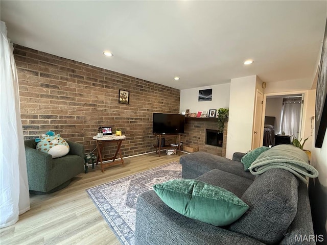 670 Coeur De Royale Dr Unit A, Creve Coeur, MO 63141 - living room with brick wall, wood finished floors, a fireplace, and recessed lighting