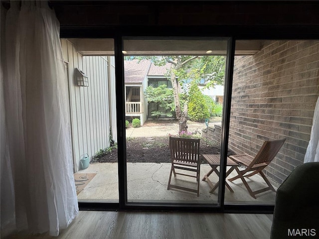 670 Coeur De Royale Dr Unit A, Creve Coeur, MO 63141 - doorway featuring wood finished floors and brick wall
