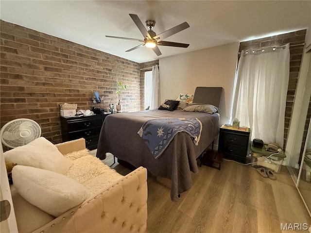 670 Coeur De Royale Dr Unit A, Creve Coeur, MO 63141 - bedroom with brick wall, light wood-type flooring, and ceiling fan
