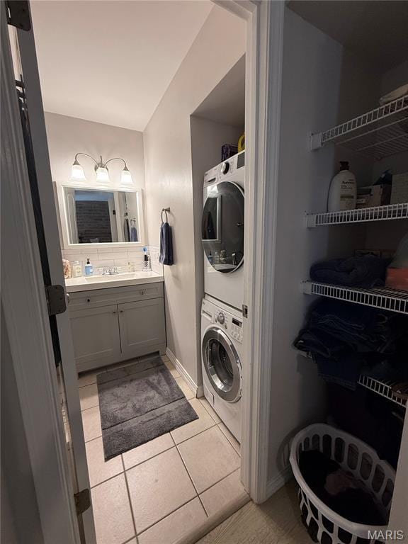 670 Coeur De Royale Dr Unit A, Creve Coeur, MO 63141 - laundry area with stacked washer / dryer and light tile patterned floors