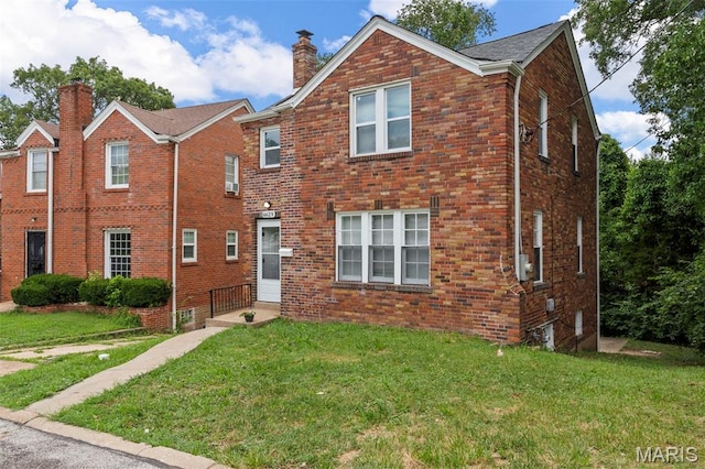 6629 Barken Ave, Northwoods, MO 63121 - traditional-style home featuring a chimney, brick siding, and a front yard