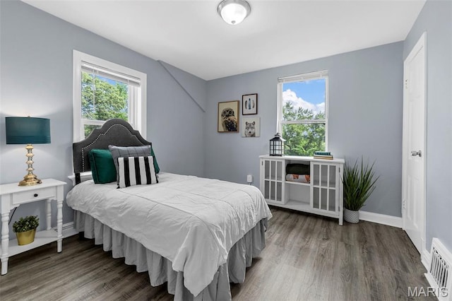 6629 Barken Ave, Northwoods, MO 63121 - bedroom featuring multiple windows and wood finished floors