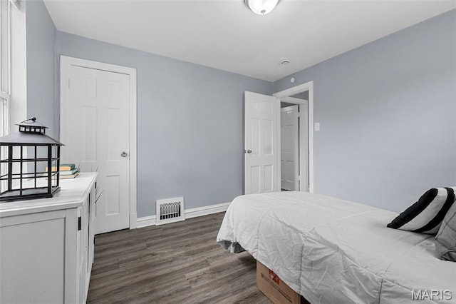 6629 Barken Ave, Northwoods, MO 63121 - bedroom featuring dark wood-type flooring and baseboards
