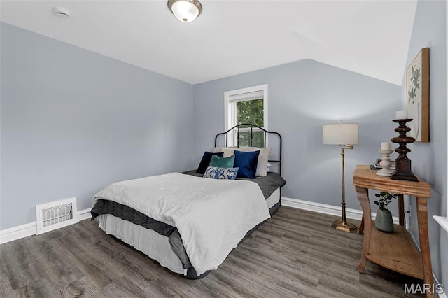 6629 Barken Ave, Northwoods, MO 63121 - bedroom with wood finished floors and lofted ceiling