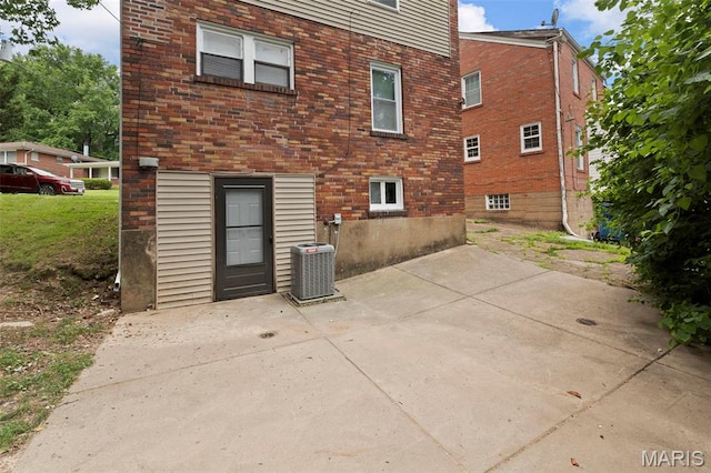6629 Barken Ave, Northwoods, MO 63121 - rear view of house with a patio area and brick siding