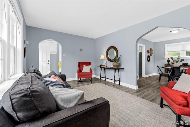 6629 Barken Ave, Northwoods, MO 63121 - living area featuring arched walkways and wood finished floors