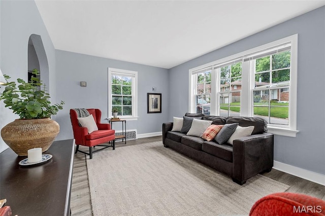 6629 Barken Ave, Northwoods, MO 63121 - living room with light wood-style floors and arched walkways