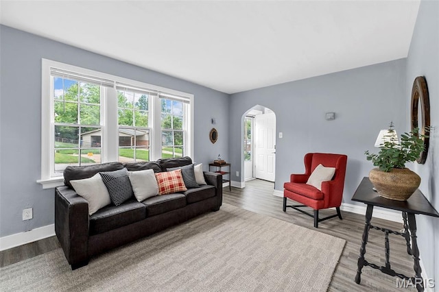 6629 Barken Ave, Northwoods, MO 63121 - living room with arched walkways and wood finished floors