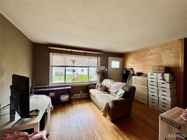 5540 Arthur Ave, Saint Louis, MO 63139 - living room featuring wood finished floors and wood walls