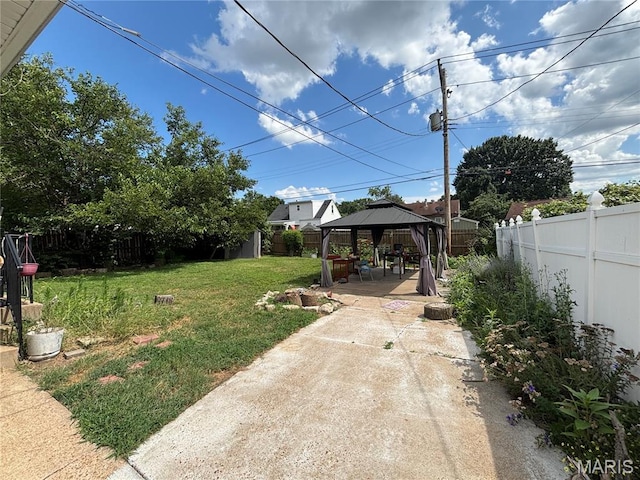5540 Arthur Ave, Saint Louis, MO 63139 - fenced backyard with a gazebo, a patio, and a storage unit