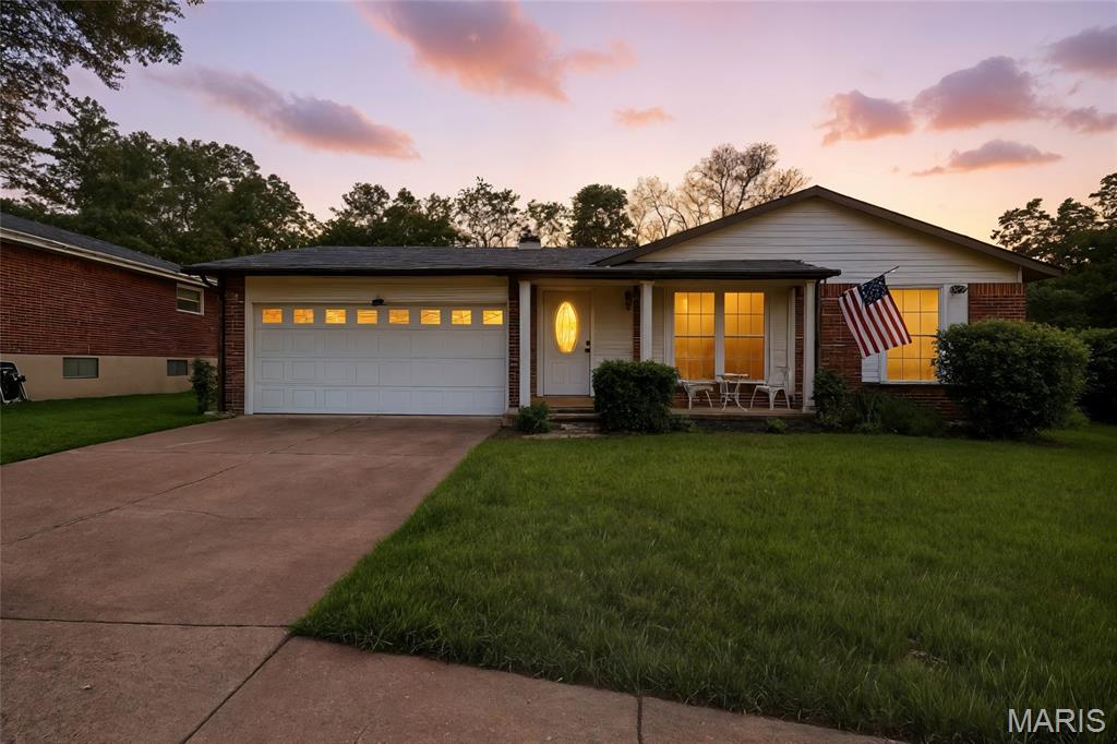 5621 Chalet Manor Ct, Saint Louis, MO 63129 - single story home featuring concrete driveway, covered porch, brick siding, and a front yard