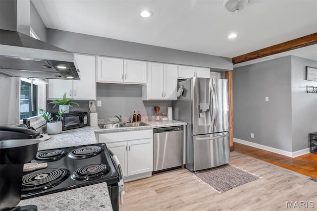 962 Buckeye Dr, Ferguson, MO 63135 - kitchen with appliances with stainless steel finishes, wall chimney exhaust hood, light countertops, white cabinets, and recessed lighting