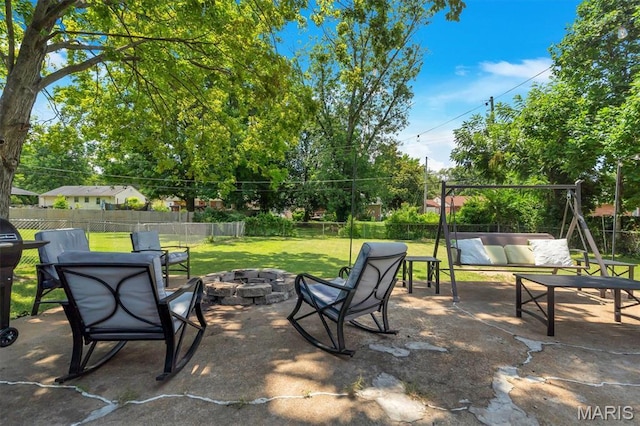 962 Buckeye Dr, Ferguson, MO 63135 - fenced backyard with an outdoor living space with a fire pit and a patio area