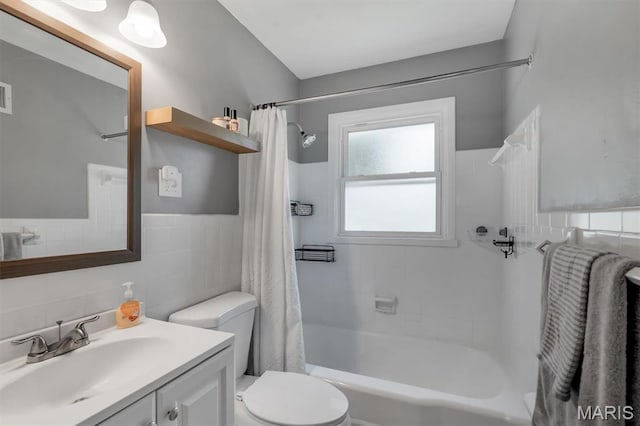 962 Buckeye Dr, Ferguson, MO 63135 - full bath with tile walls, vanity, and shower / bathtub combination with curtain