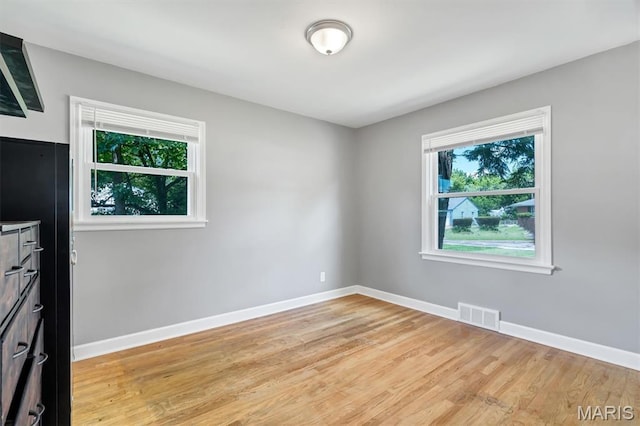962 Buckeye Dr, Ferguson, MO 63135 - empty room featuring healthy amount of natural light and light wood-type flooring