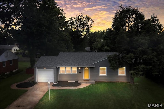 962 Buckeye Dr, Ferguson, MO 63135 - ranch-style house featuring concrete driveway, an attached garage, a yard, and a shingled roof
