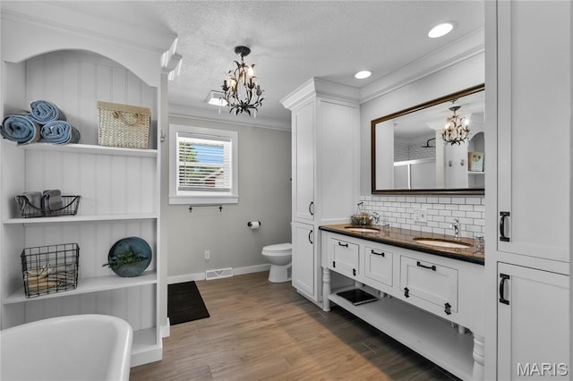1658 County Road 435, Jackson, MO 63755 - bathroom featuring a chandelier, double vanity, a soaking tub, tasteful backsplash, and ornamental molding