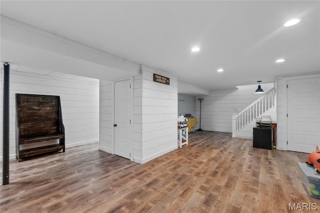 1658 County Road 435, Jackson, MO 63755 - unfurnished living room with stairway, wooden walls, recessed lighting, and wood finished floors