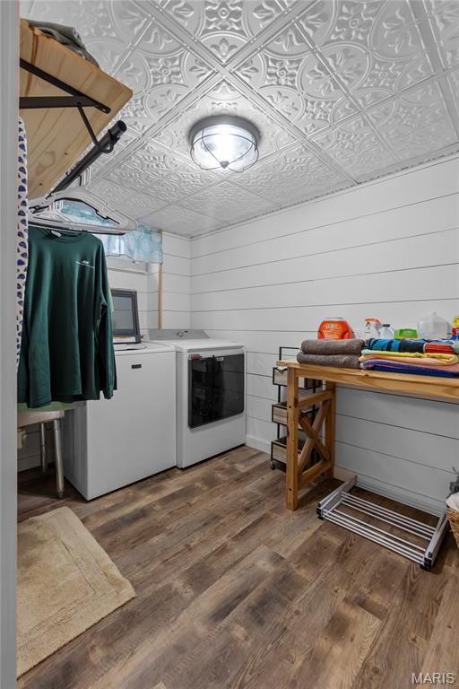 1658 County Road 435, Jackson, MO 63755 - laundry room featuring washer and dryer, an ornate ceiling, wood finished floors, and wooden walls