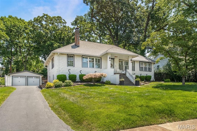 354 Frieda Ave, Kirkwood, MO 63122 - view of front of home with a chimney, an outdoor structure, a detached garage, a front yard, and stone siding