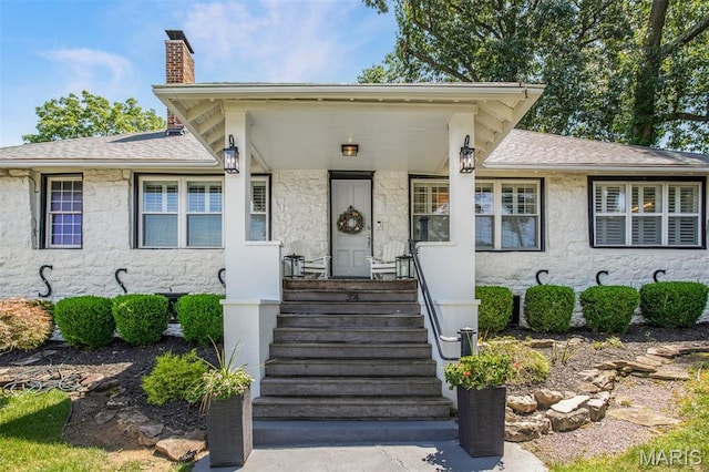 354 Frieda Ave, Kirkwood, MO 63122 - view of front facade featuring a chimney, stone siding, and a shingled roof