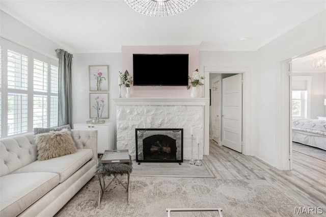 354 Frieda Ave, Kirkwood, MO 63122 - living room featuring a chandelier, crown molding, wood finished floors, and a fireplace with flush hearth