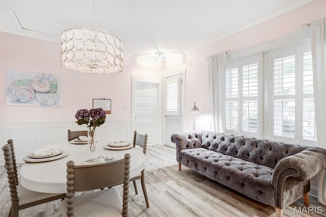 354 Frieda Ave, Kirkwood, MO 63122 - dining space featuring light wood-style floors, wainscoting, crown molding, and a decorative wall