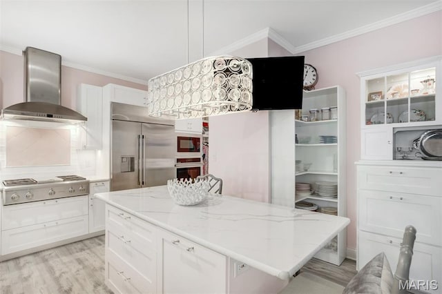 354 Frieda Ave, Kirkwood, MO 63122 - kitchen featuring built in appliances, wall chimney exhaust hood, crown molding, light wood-style flooring, and white cabinetry