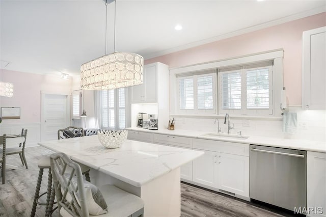 354 Frieda Ave, Kirkwood, MO 63122 - kitchen with dishwasher, a kitchen bar, crown molding, white cabinetry, and light stone countertops