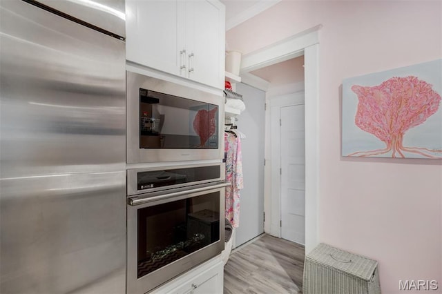 354 Frieda Ave, Kirkwood, MO 63122 - kitchen with appliances with stainless steel finishes, white cabinets, and light wood-style floors