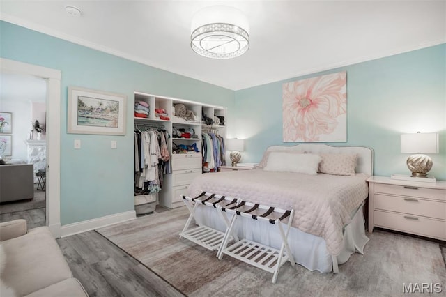 354 Frieda Ave, Kirkwood, MO 63122 - bedroom with light wood-type flooring, a closet, and crown molding